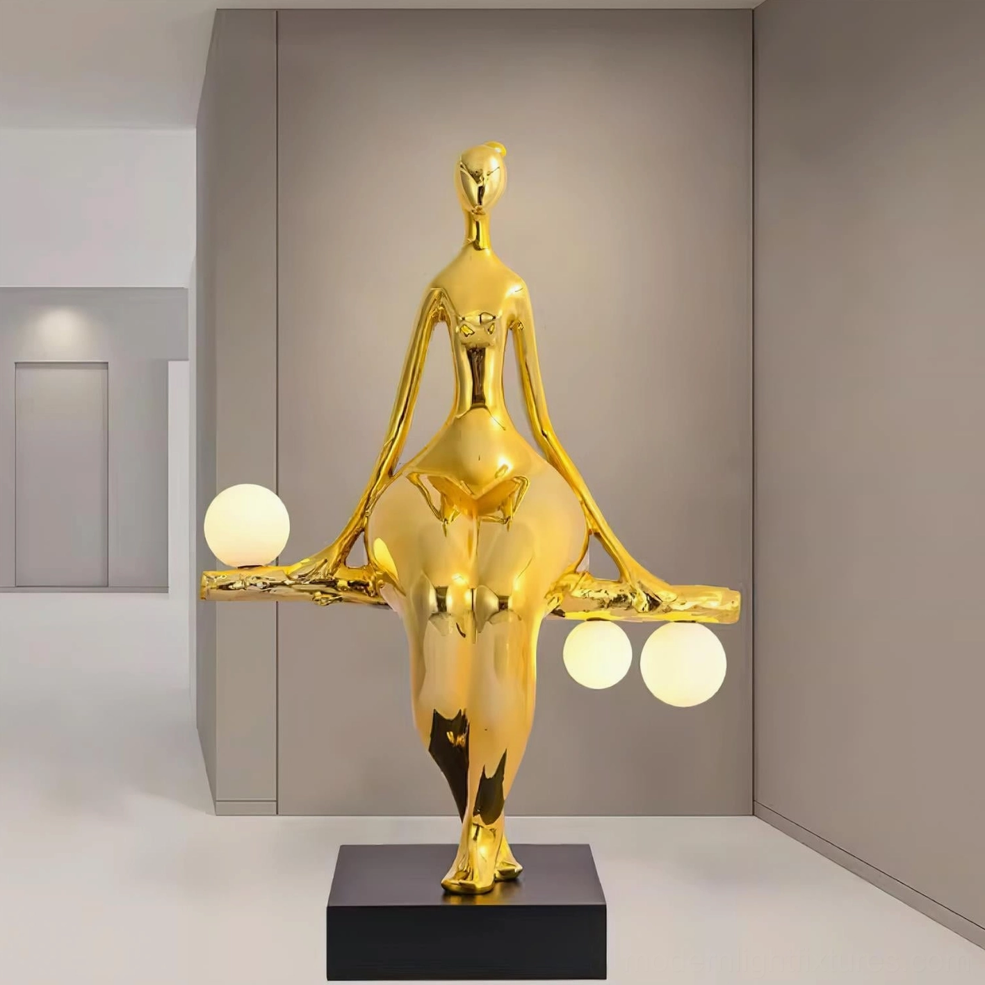 Gold finish human sculpture floor lamp with three frosted globe lights in narrow corridor, modern home interior