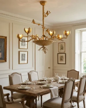 Gold Sylvaria nature-inspired chandelier illuminated overhead in traditional dining room with paneled walls and warm ambient lighting