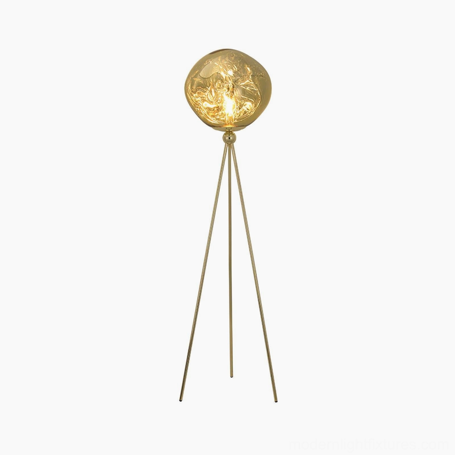 Modern gold tripod floor lamp with round molten lava glass shade in contemporary interior styling