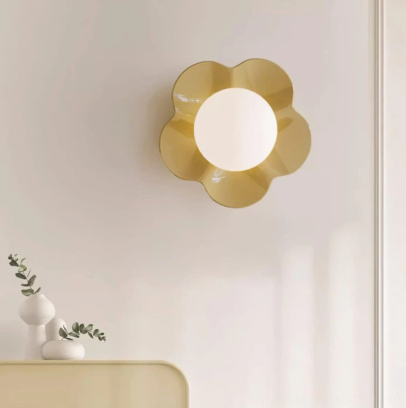 Golden yellow Fleur wall sconce mounted on living room wall with console table decor - warm modern wall lighting