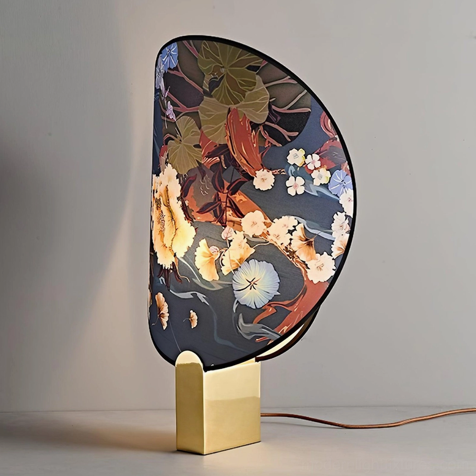 Illuminated gothic ravens flowers table lamp showing warm light diffusion through fabric shade with grey minimalist background