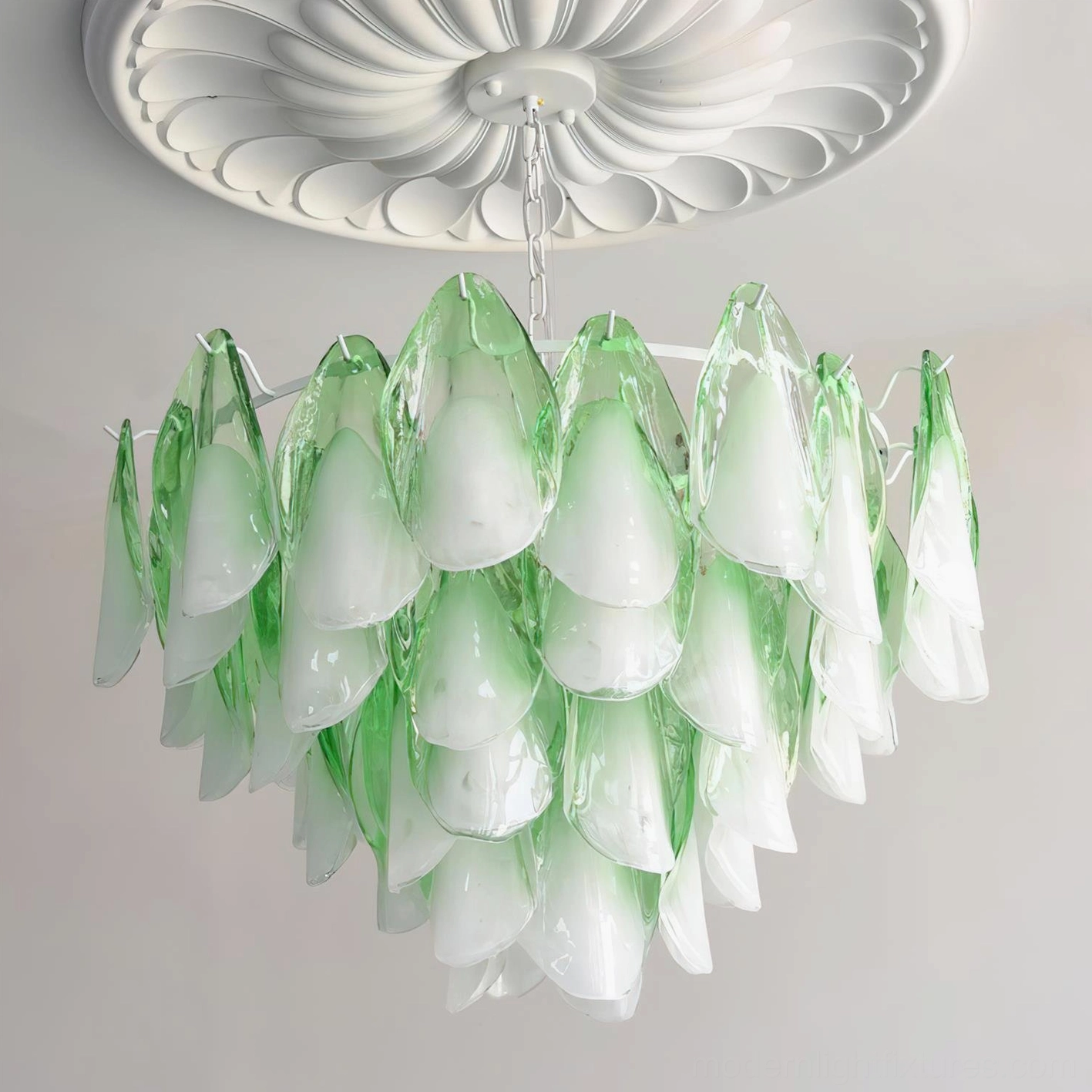 Overhead view of gradient glass petal chandelier with cream white and green petals on silver metal fixtures