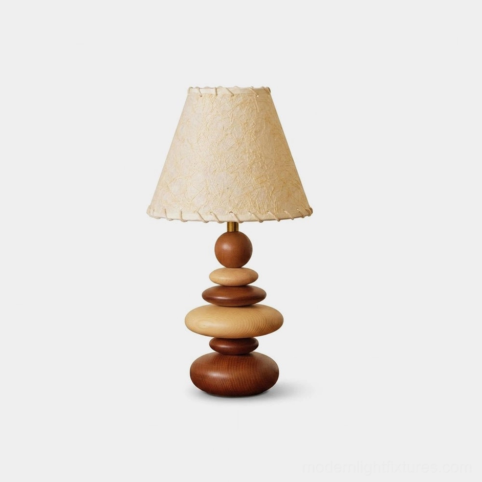 Grainelle stacked wood table lamp with walnut and beige tones, showing layered white-ash base and whipstitched linen shade on white background