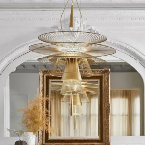 Gold Gravity chandelier installed in French neoclassical living room with carved arch details