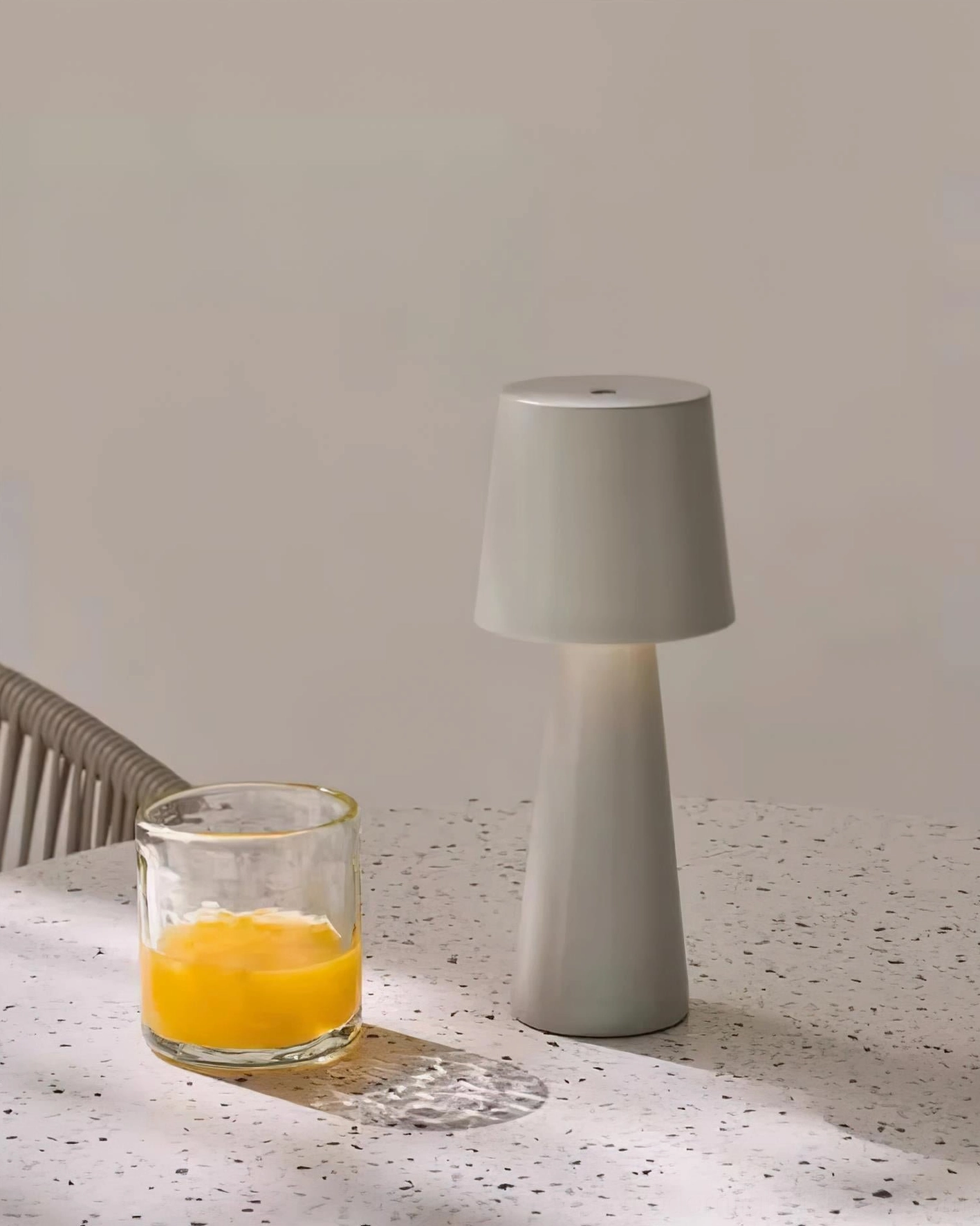 Light gray matte tapered table lamp dining table contemporary setting soft lighting