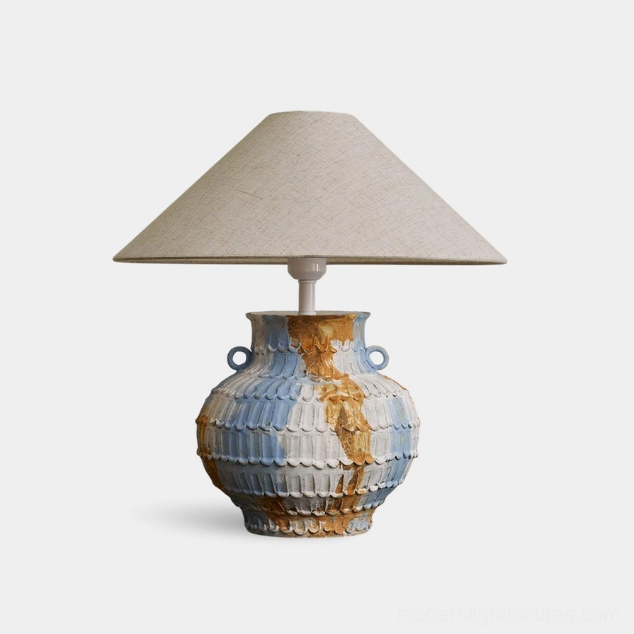 Grazie handcrafted ceramic table lamp featuring sculptural blue and beige artisanal pottery base with scalloped textures and twin ring handles - modern table lighting fixture front view