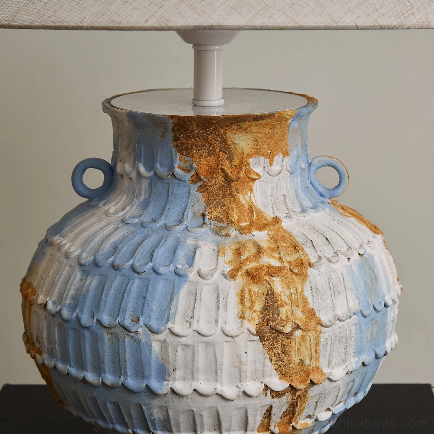 Close-up detail of Grazie ceramic table lamp base showing hand-thrown pottery texture ribbed surface marbled blue-brown-white artisanal glazed finish with twin ring handles
