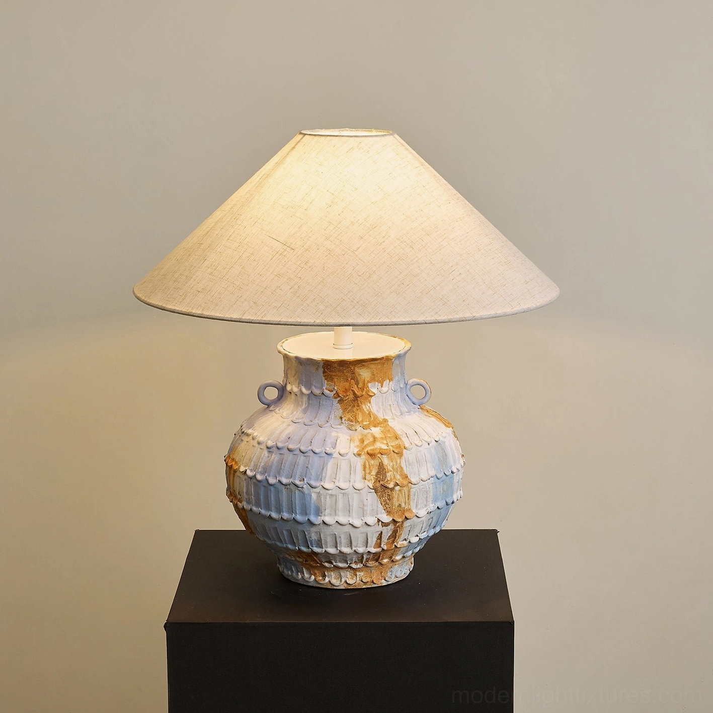 Grazie table lamp right front angle view displaying sculptural ceramic base with functional twin ring handles and artisanal blue-brown glazed finish - handcrafted pottery lighting