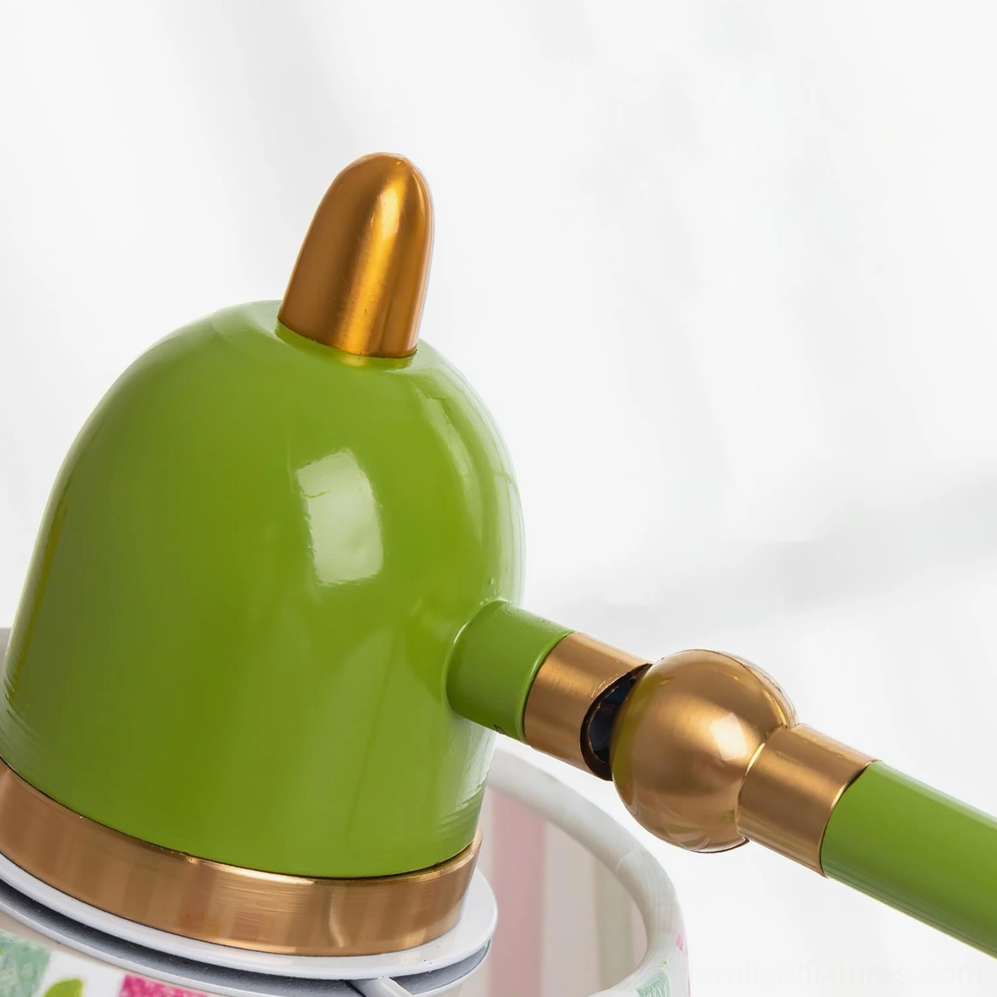Green articulated desk lamp with flexible positioning capability and decorative striped fabric shade