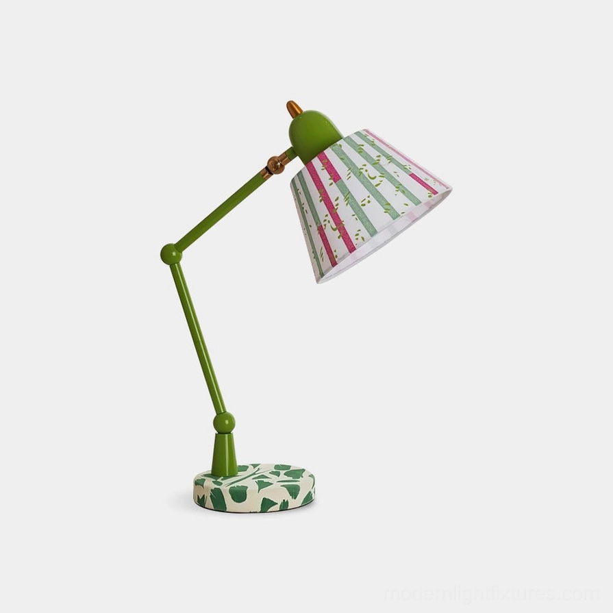 Green swing arm table lamp with artistic striped shade and leaf motif base, front three-quarter view on white background