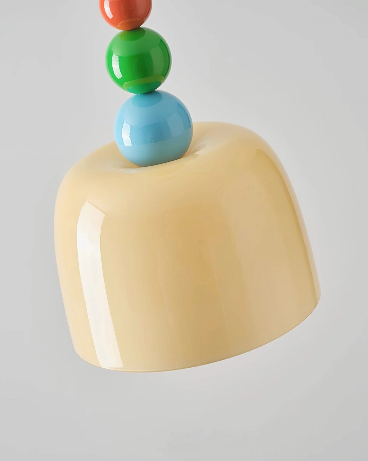Green beaded pendant lamp finial with cream glass dome in contemporary interior