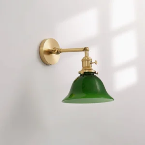 Side view of emerald green glass bell-shaped wall sconce with brass metal structure