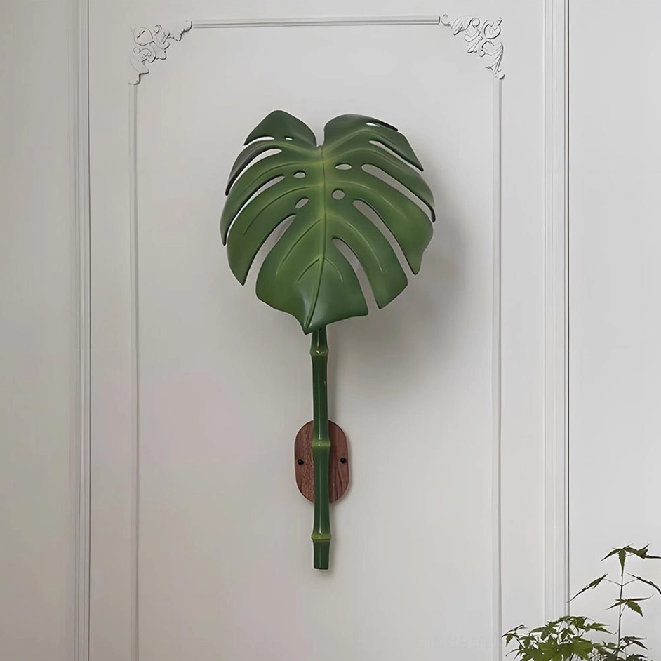 Green botanical wall lamp as focal point above console table in transitional home decor style