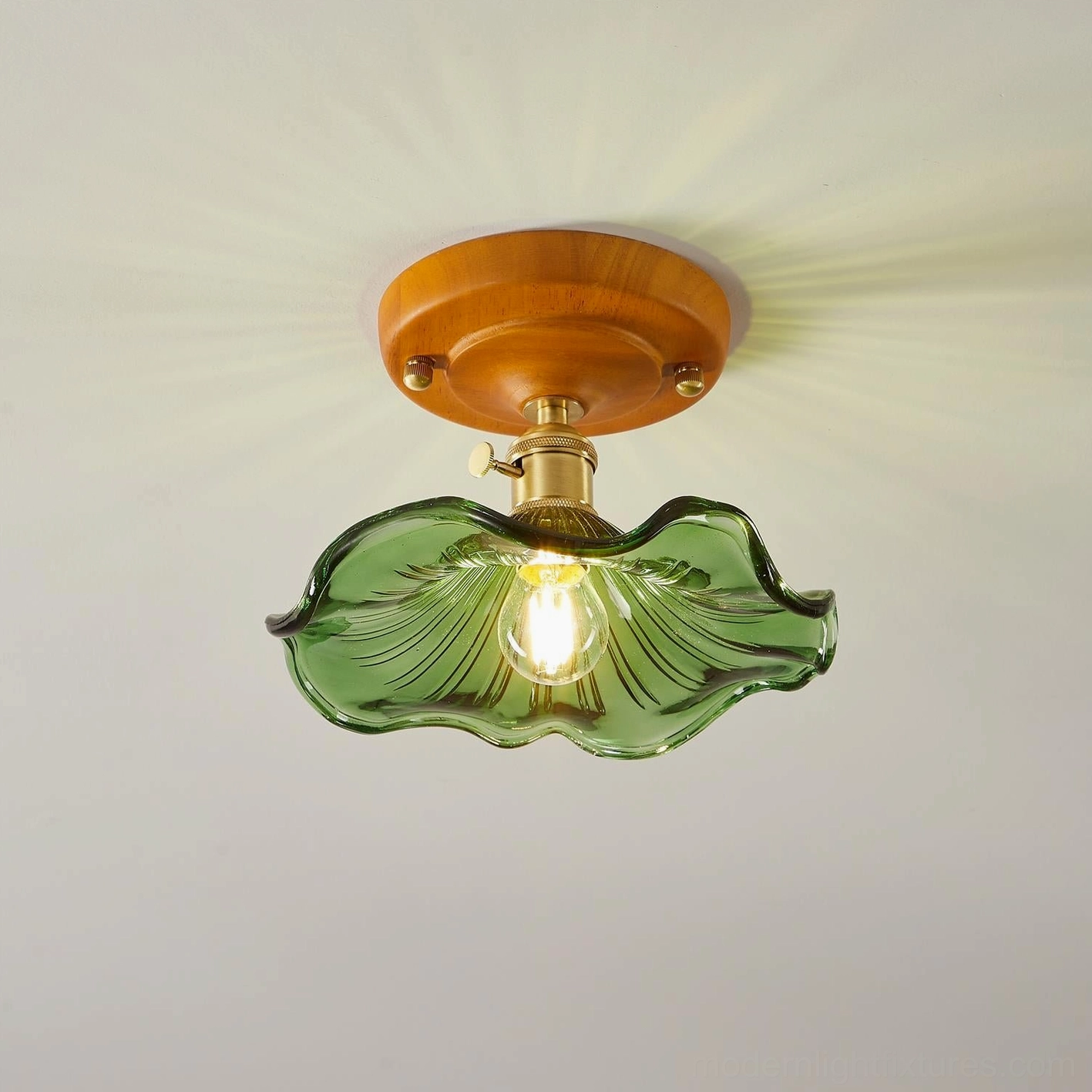 Full overhead view of illuminated green wavy glass ceiling fixture showing complete wavy shade design