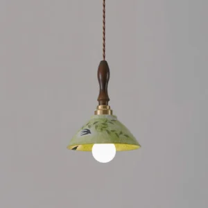Green ceramic pendant lamp with intricate hand-painted botanical motifs, dark wood stem and brass hardware