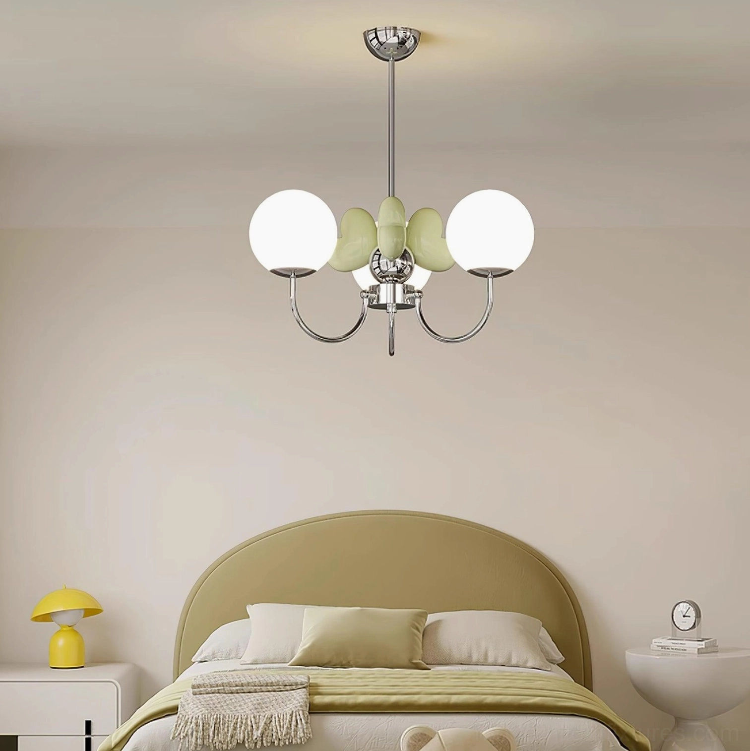 Green petal chandelier above yellow bed in warm pastel bedroom - ambient bedroom lighting solution