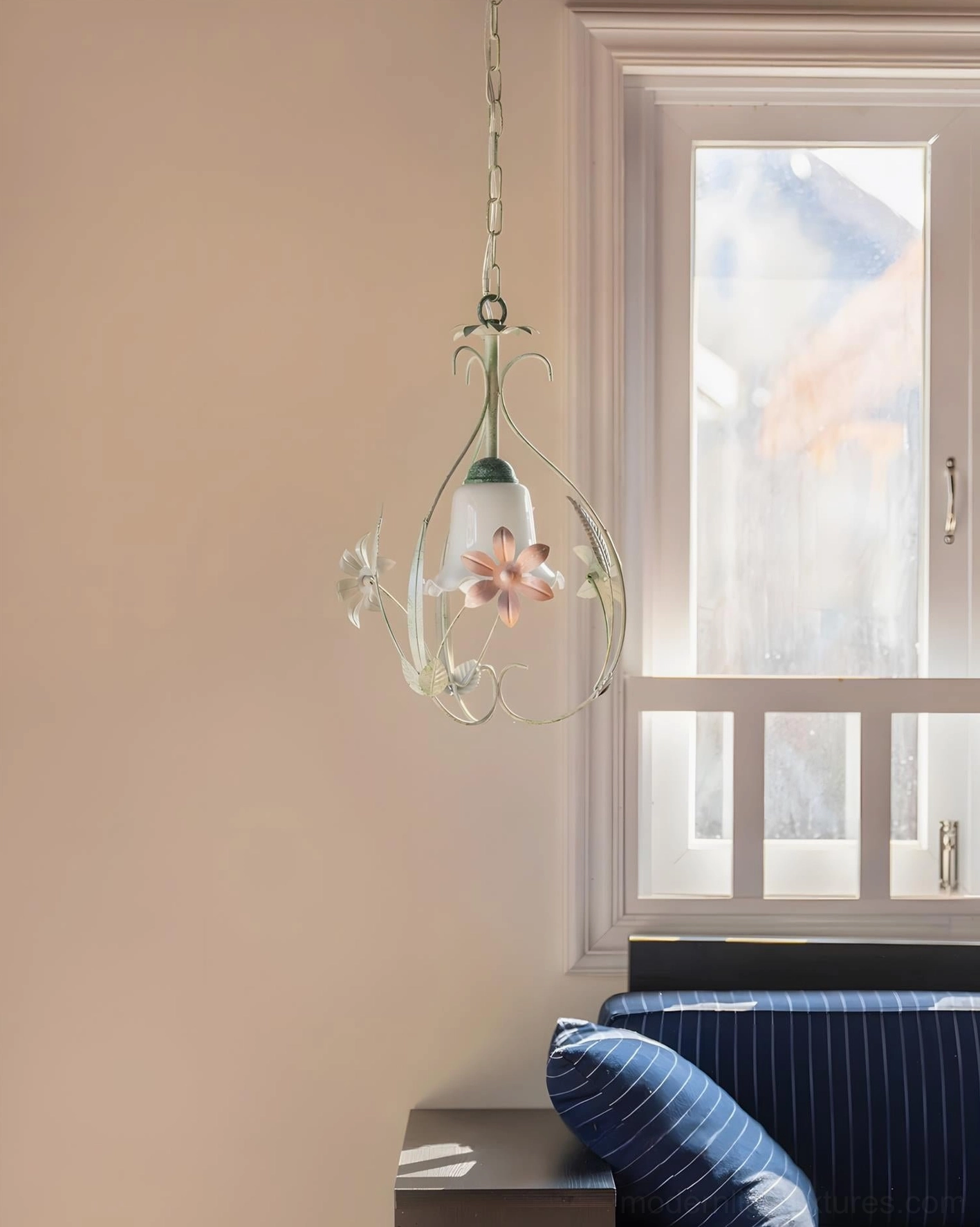 Green cottage pendant light showing metal frame construction with botanical leaf and stem details in product showcase
