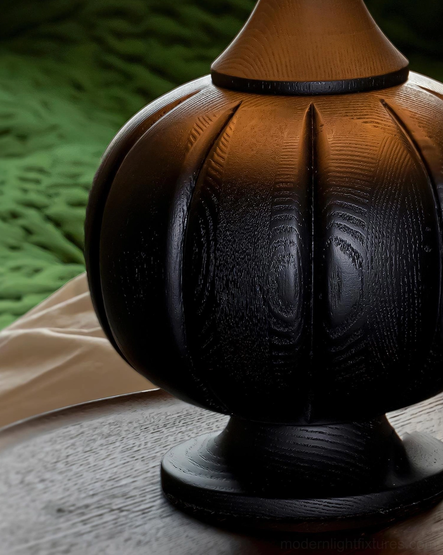 Striped wooden table lamp with green cream fabric shade displayed in Scandinavian living room interior