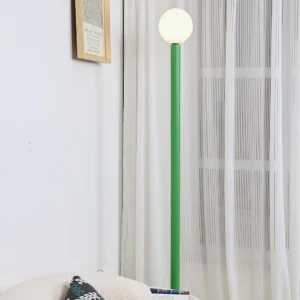 Green Dotline floor lamp in Scandinavian living room setting with sheer curtains - minimalist interior design inspiration