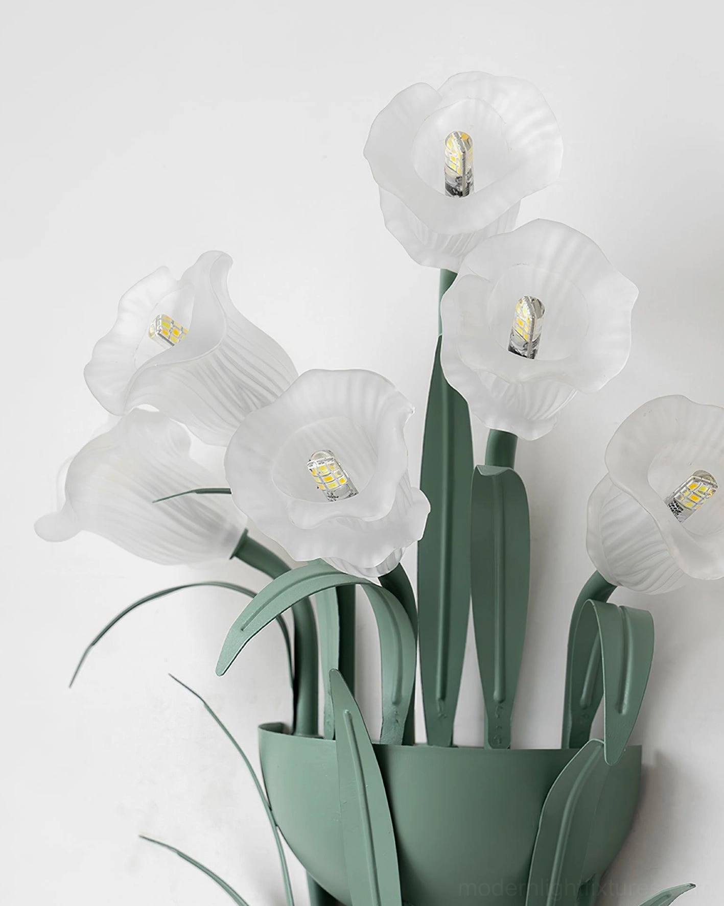 Green botanical wall sconce in living room setting, decorative floral wall light ambient illumination