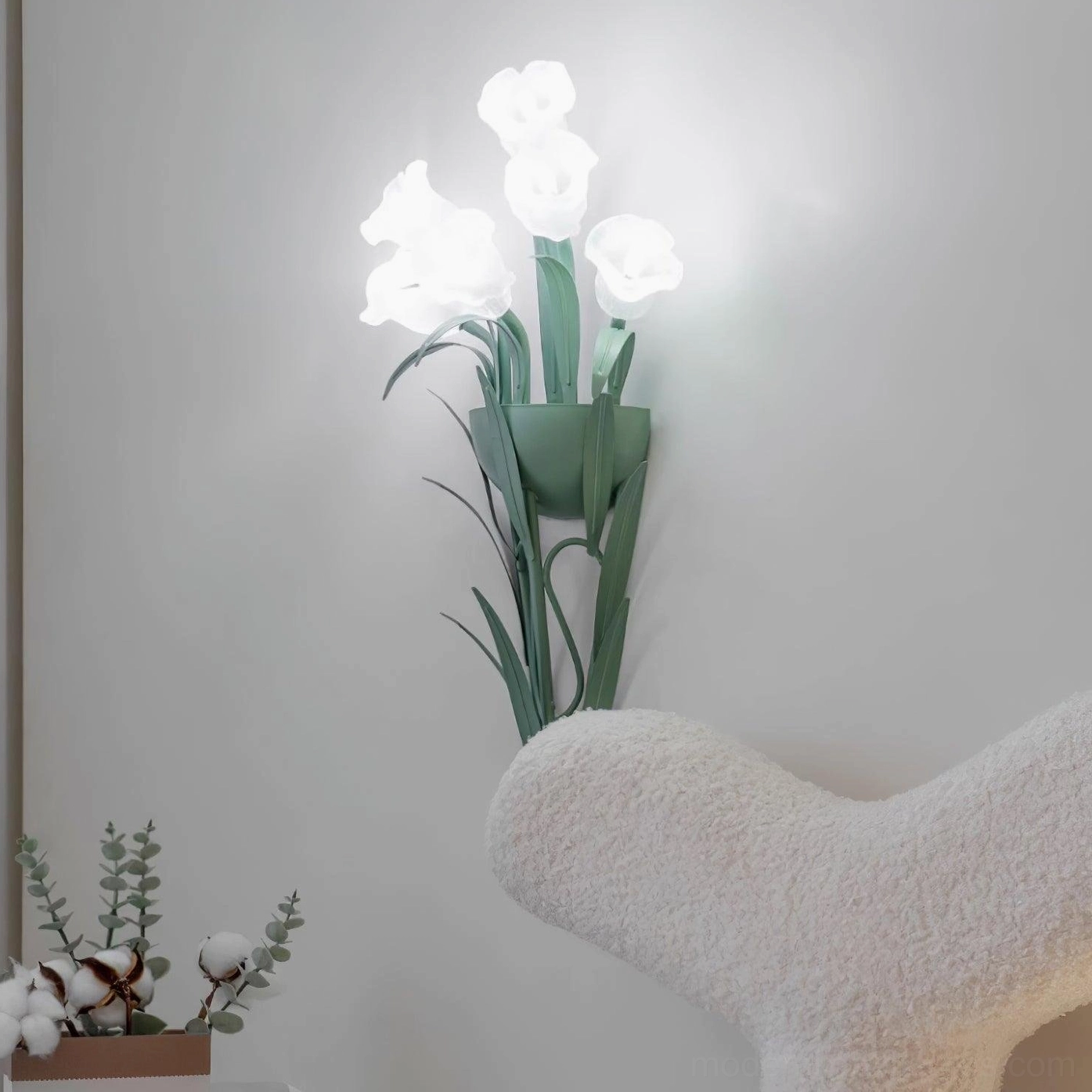 Green and white floral wall sconce close-up detail view, botanical design artificial flowers metal frame