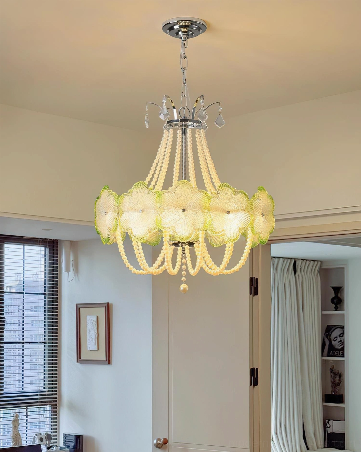 Green botanical flower glass chandelier suspended in modern home with chrome metal hardware and warm lighting