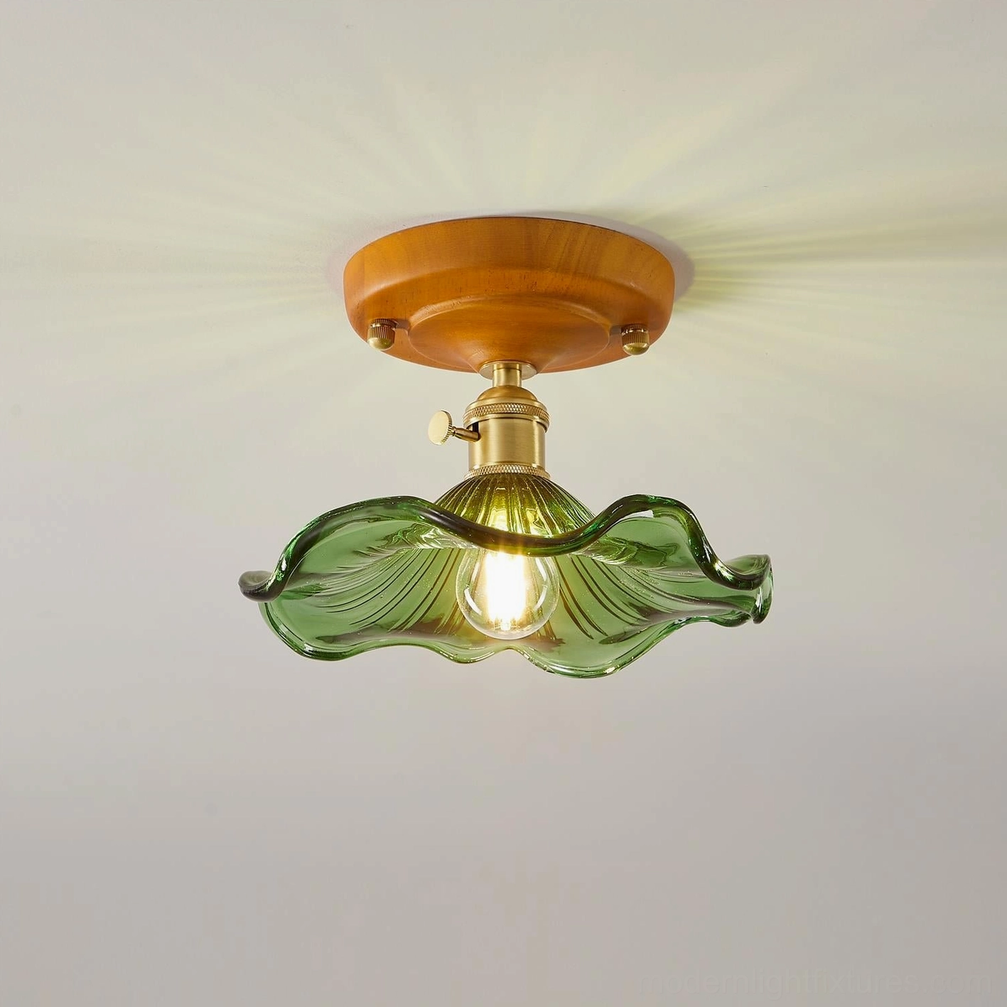 Illuminated green ruffled glass ceiling light with visible bulb glow through textured shade