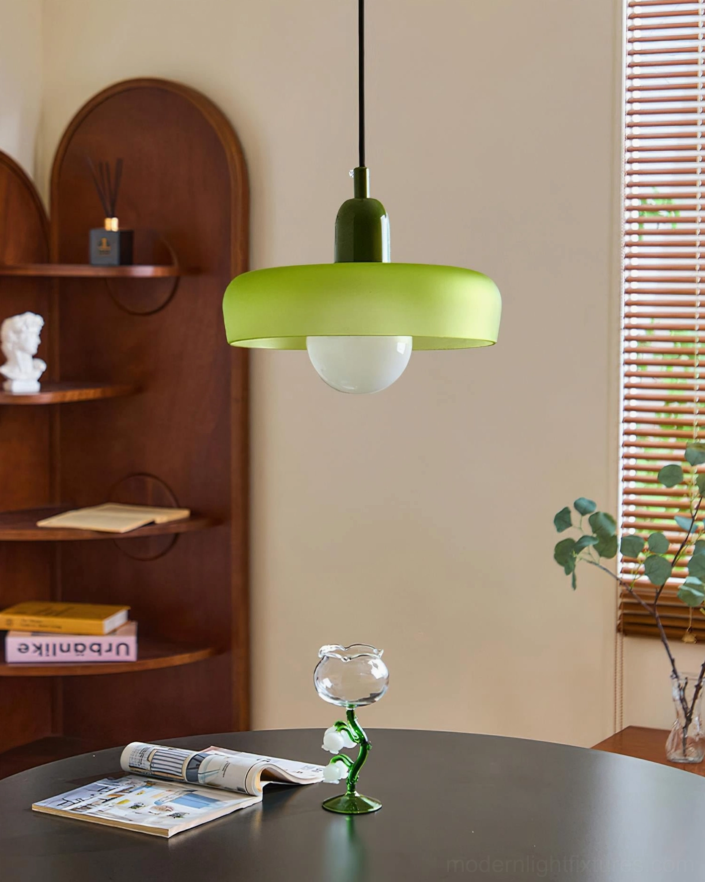 Green frosted glass donut pendant light with dark green holder, overhead view in vintage home living area showing contemporary retro design