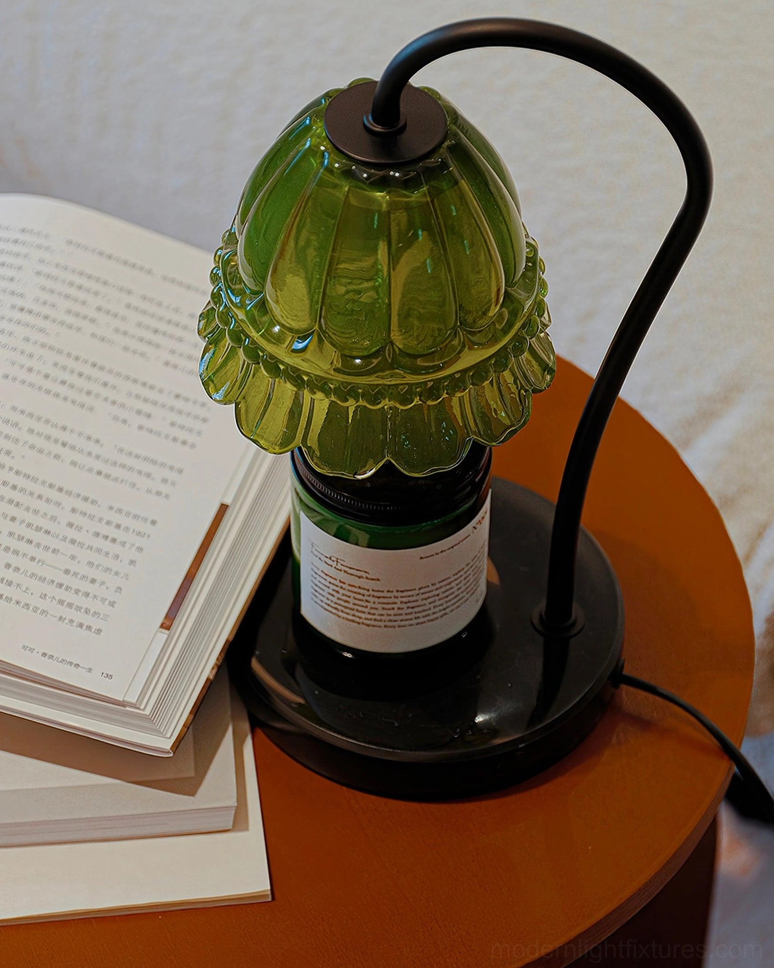 Left angle view of green floral glass candle warmer lamp on home desk