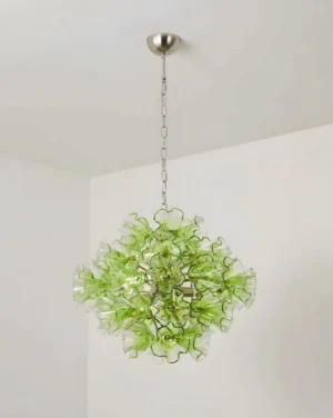 Green floral glass pendant light fixture installed in minimalist white room with silver ceiling chain and chrome mounting
