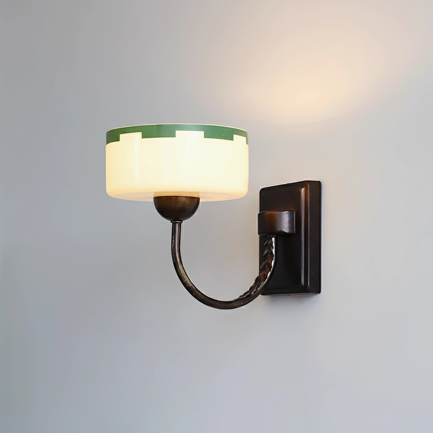 Green glass wall sconce mounted on gray wall with illuminated vintage design, Art Deco lighting fixture