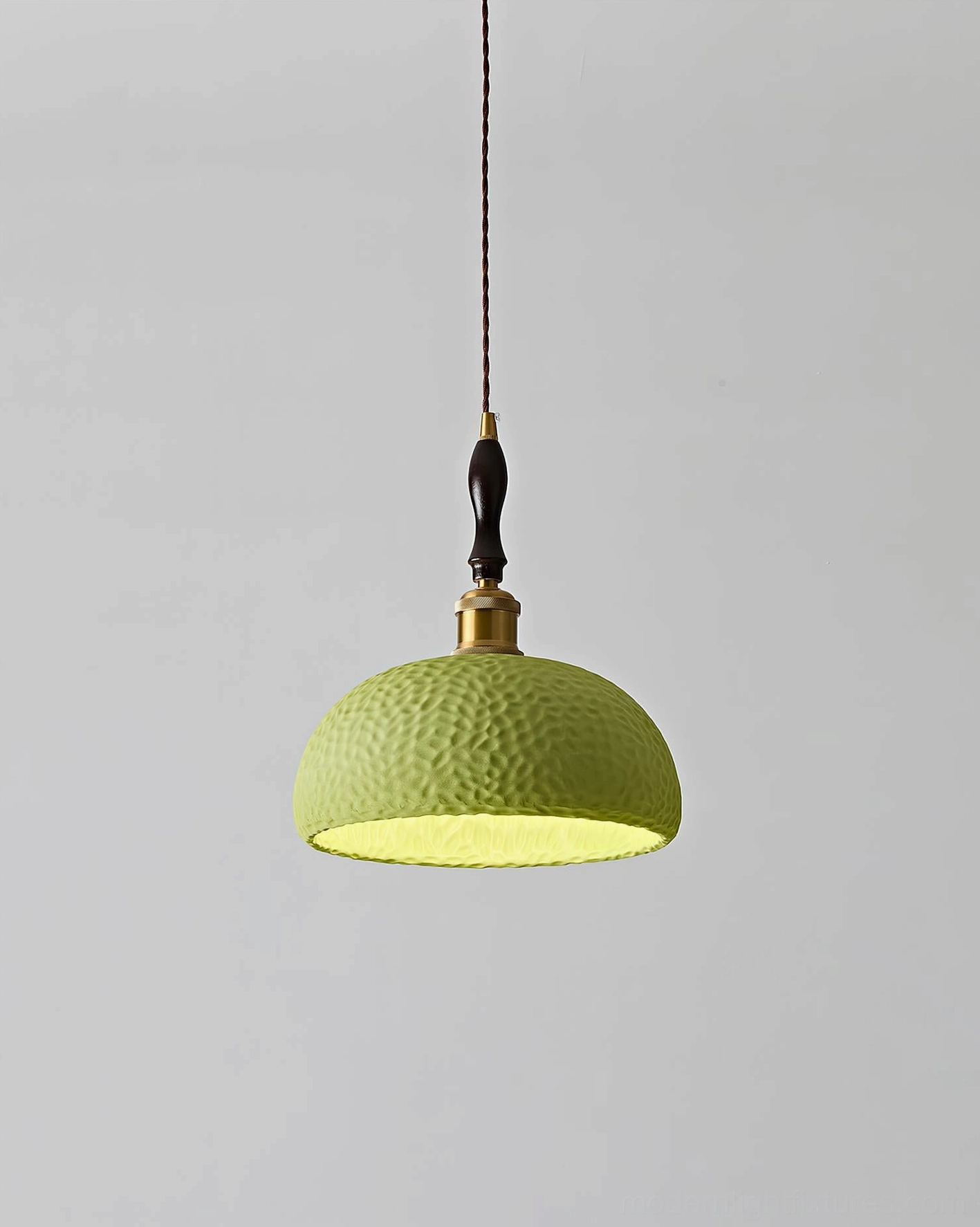 Green textured resin dome pendant lamp with hammered surface finish, front hanging studio view