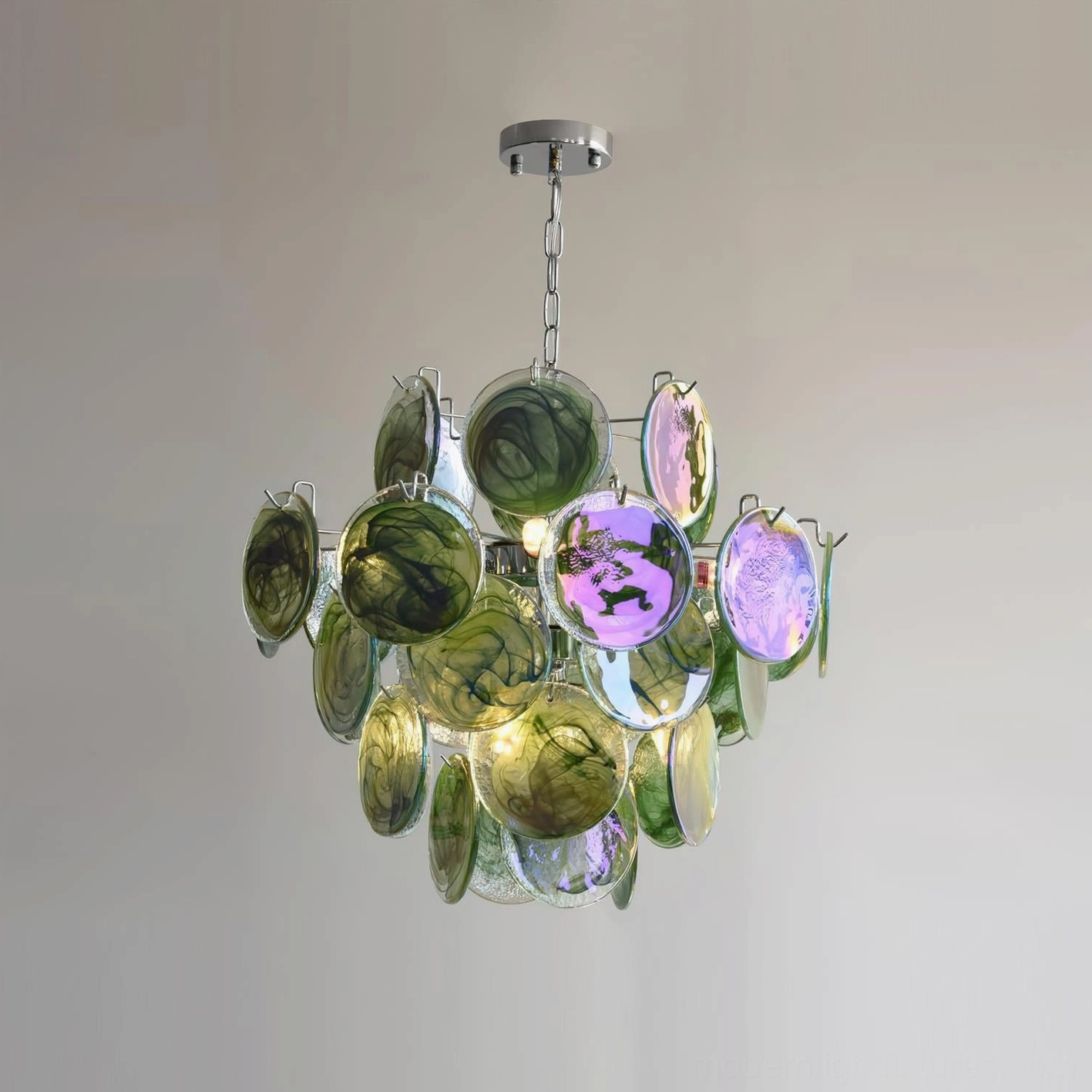 Green iridescent glass disc chandelier hanging view against warm neutral wall, coastal luxury art glass style