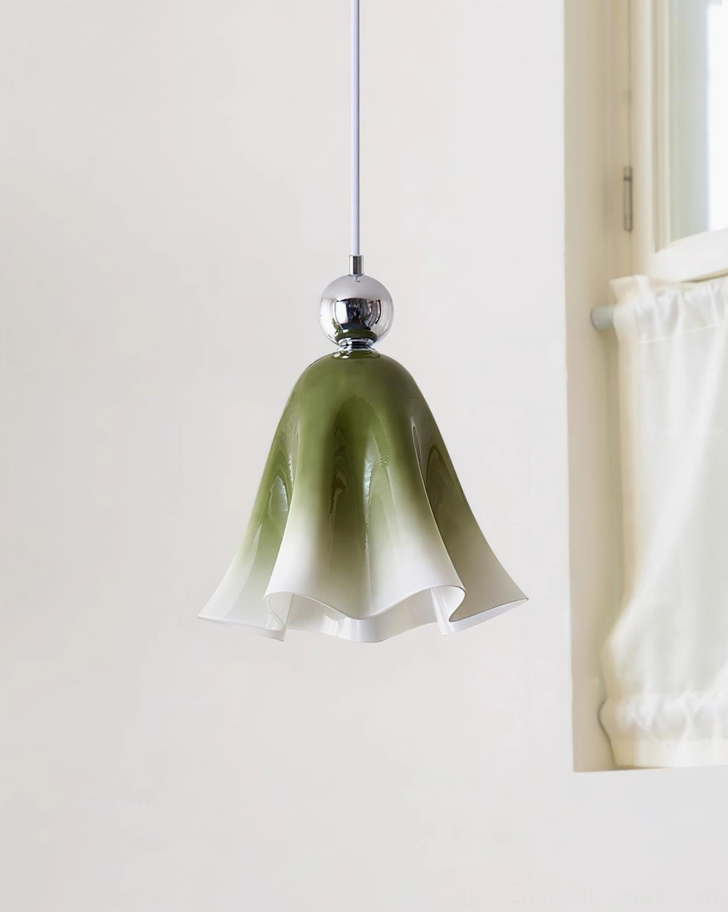 Green gradient Vellia lily pendant lamp side view in residential setting with window and curtains