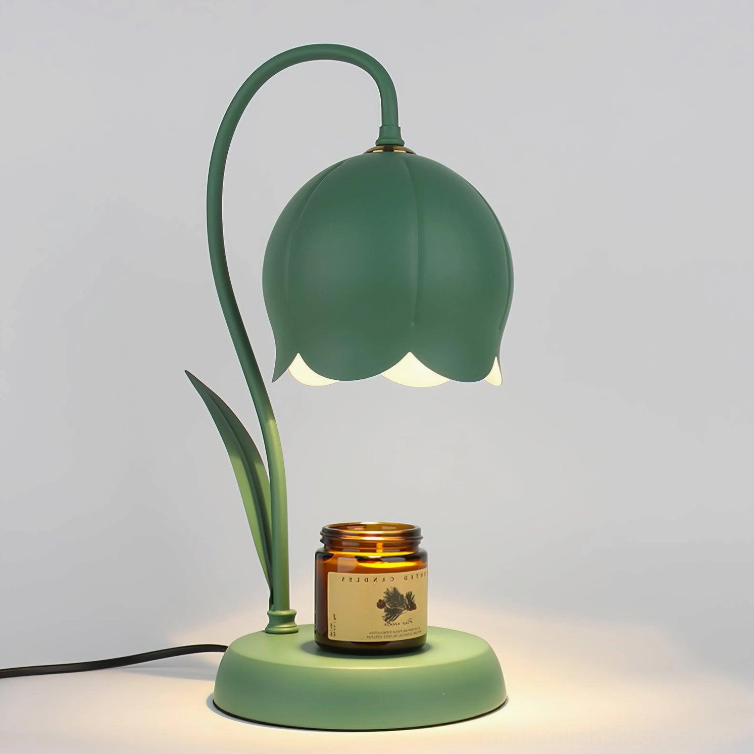 Matte dark green lily candle warmer lamp front view with amber scented candle and exposed power cord