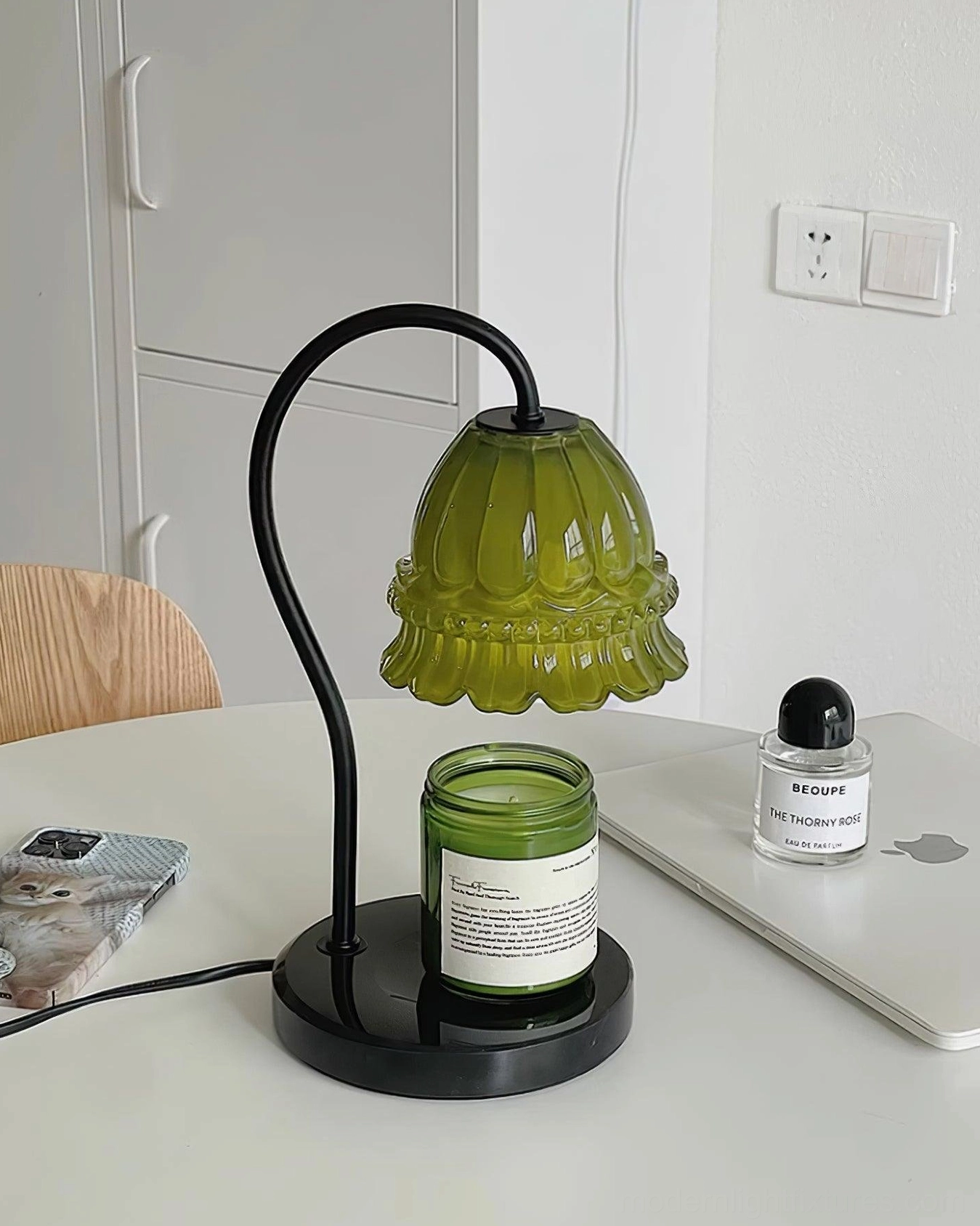 Modern green marble base candle warmer lamp on vintage home desk with ambient lighting