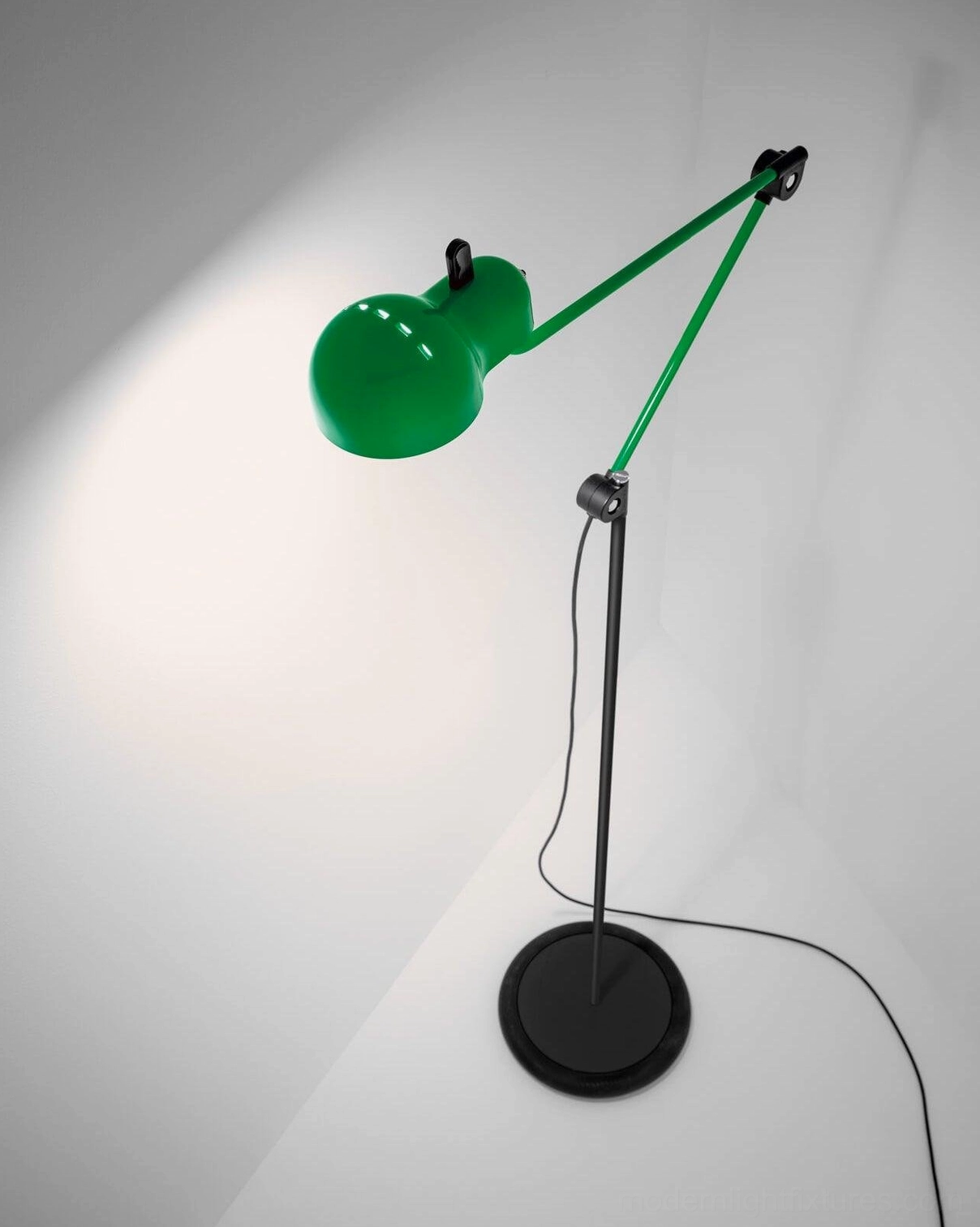 Green metallic swing arm floor lamp with three-quarter view showing cylindrical shade and articulating joints