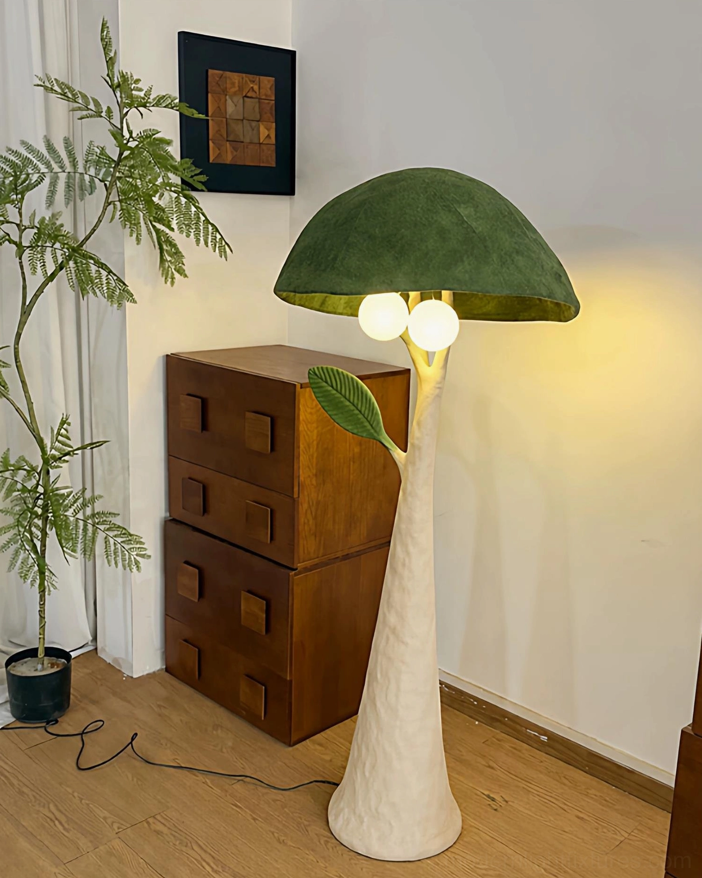 Green mushroom floor lamp beside minimalist wooden dresser, side view showing textured resin pole and leaf detail