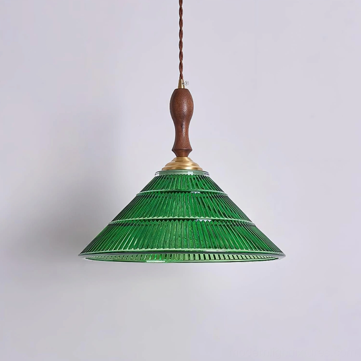 Vintage green pendant lamp illuminated showing light diffusion through fluted glass shade