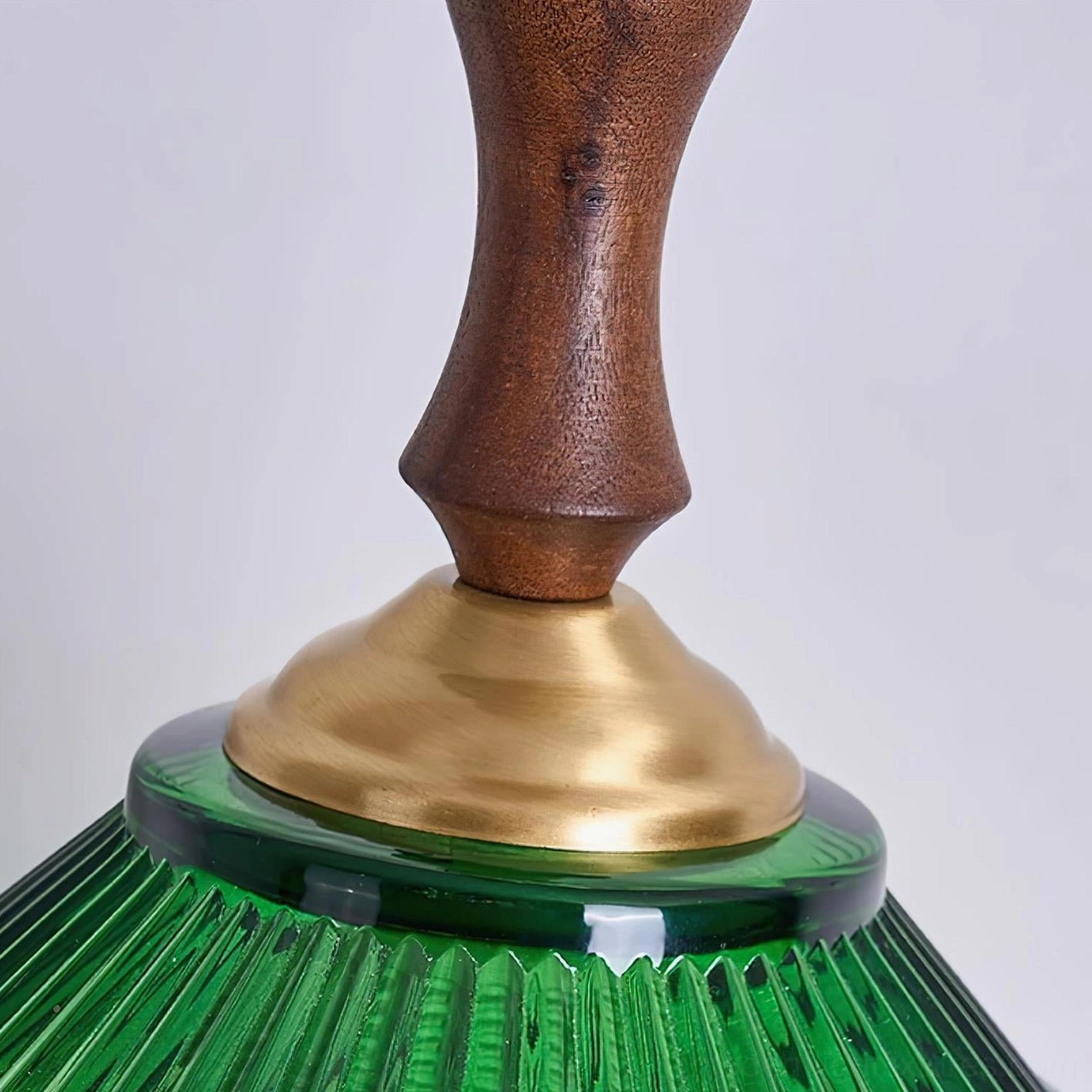 Green glass pendant light with brass accents mid-century modern interior styling