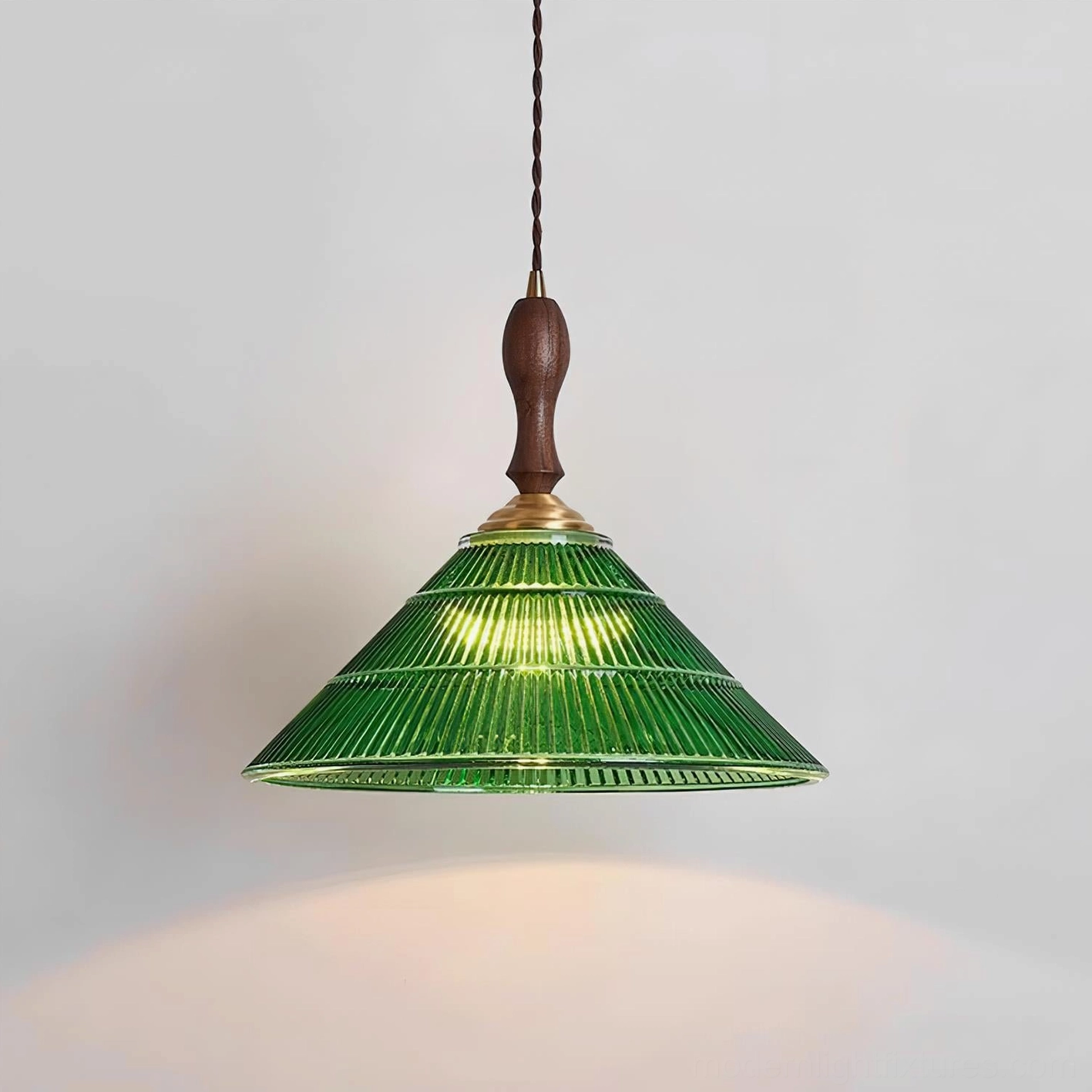 Green glass pendant light three-quarter view showing sculptural design and proportions