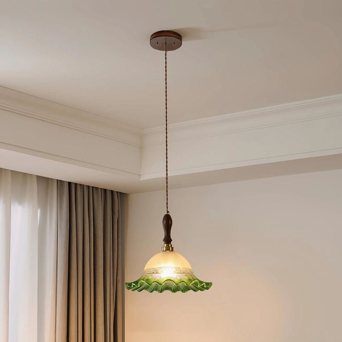 Green gradient pendant light installed in bedroom with sheer curtains and neutral wall decor
