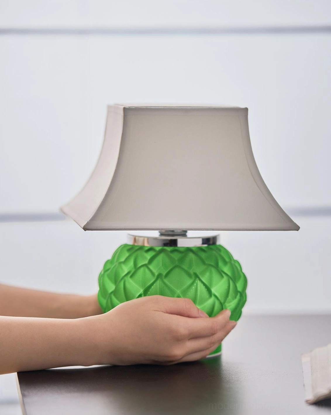 Green Petaluxe table lamp displayed on home office desk with three-quarter angle view showing petal texture detail