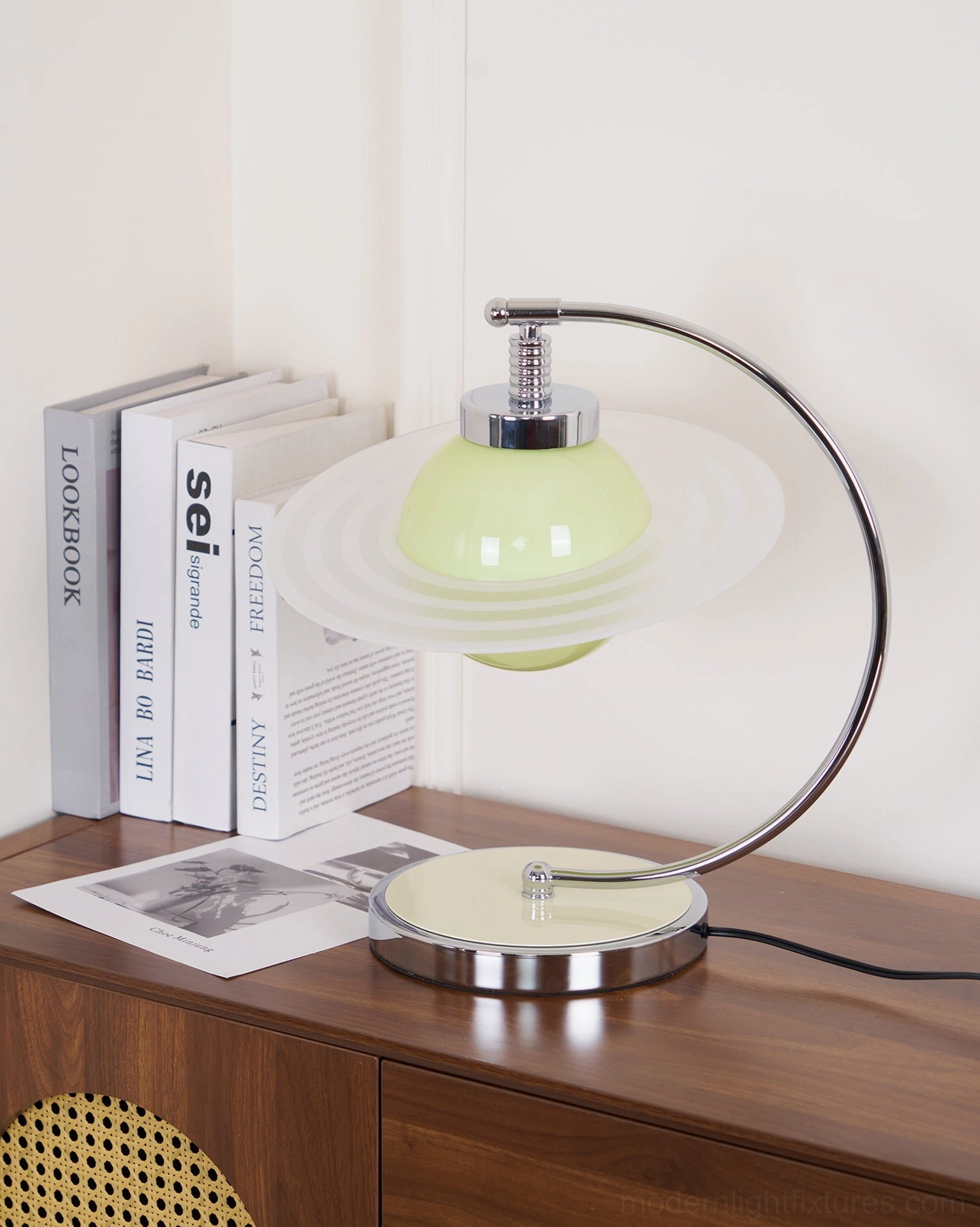 Right close-up view of green planet table lamp showing chrome metal base and arched support structure