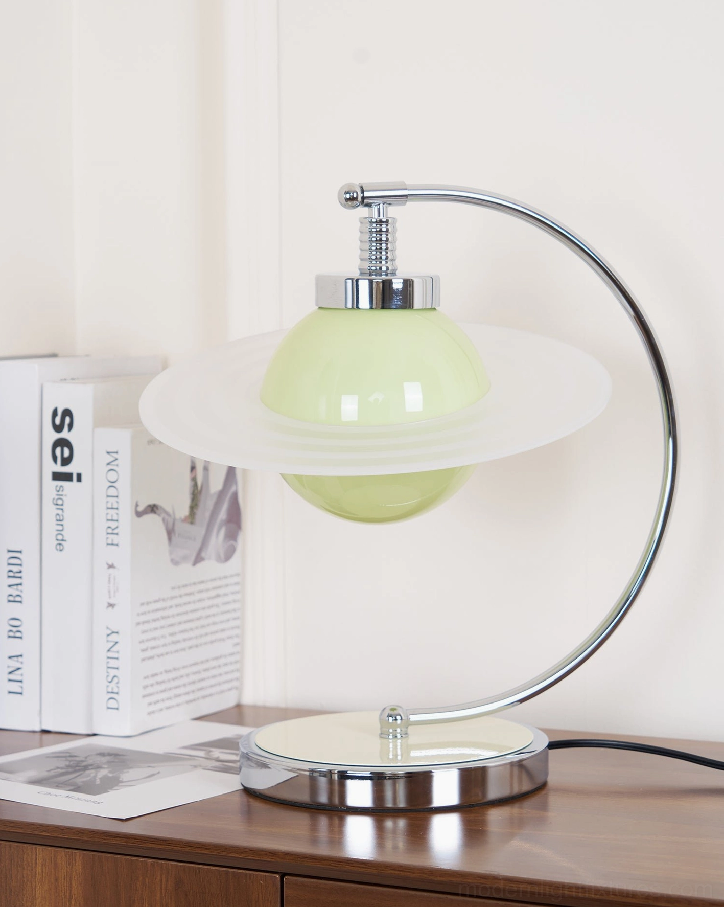 Left side perspective of contemporary green globe lamp with polished chrome metal frame and base