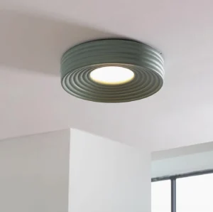 Matte sage green ribbed ceiling light viewed from below, showing layered texture and modern minimalist design