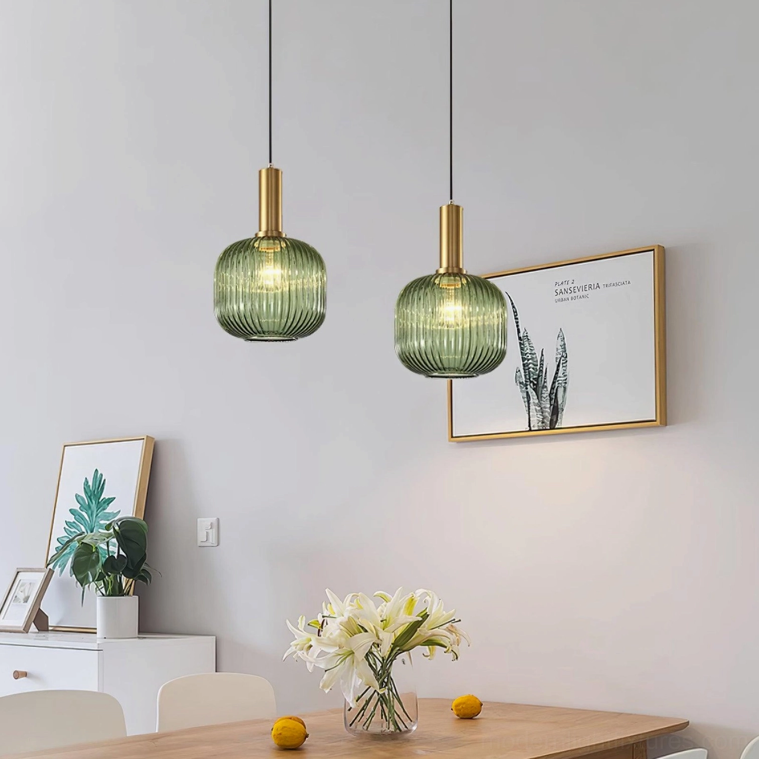 Two matching green ribbed glass pendant lamps hanging in modern minimalist dining room with pendant light fixtures