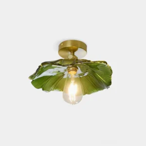Green ruffled glass semi-flush ceiling light with brass base and exposed bulb, front overhead studio view