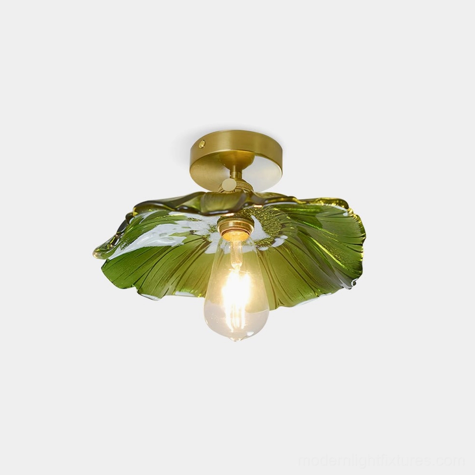 Green ruffled glass semi-flush ceiling light with brass base and exposed bulb, front overhead studio view