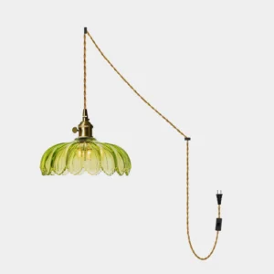 Green fluted glass plug-in pendant light with scalloped petal shade and brass fixture on white background